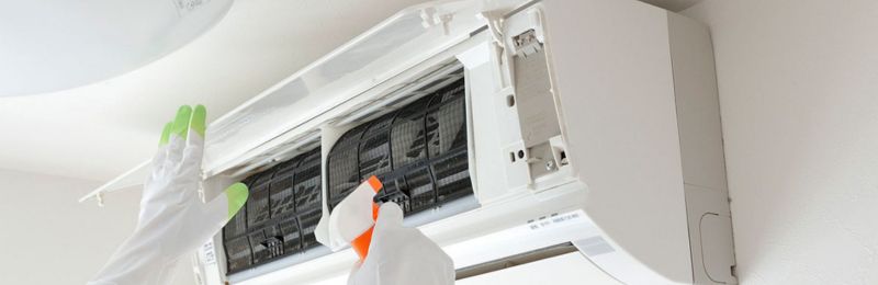 HVAC technician repairing an air conditioner unit in Rancho Santa Fe CA